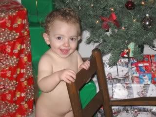 Little naked boy by the tree